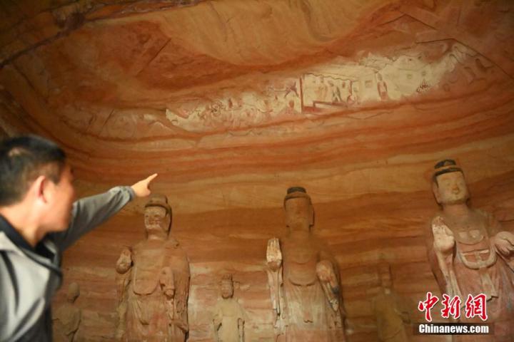 7月15日，甘肅省平涼市涇川縣百里石窟長廊中的南石窟寺1號窟內，工作人員介紹窟內僅存的浮雕——佛傳故事。百里石窟長廊位于涇川縣境內，由512個石窟、5眼窟中石井組成，現(xiàn)存王母宮石窟、鳳凰山石窟、南石窟寺、丈八寺石窟、羅漢洞石窟、太山寺石窟等規(guī)模較大的石窟群，還有數(shù)量眾多的小石窟群。南石窟寺開鑿于北魏永平三年，其中1號窟屬于大型七佛窟，七佛高達6米。中新社記者 李亞龍 攝</p>
<p>